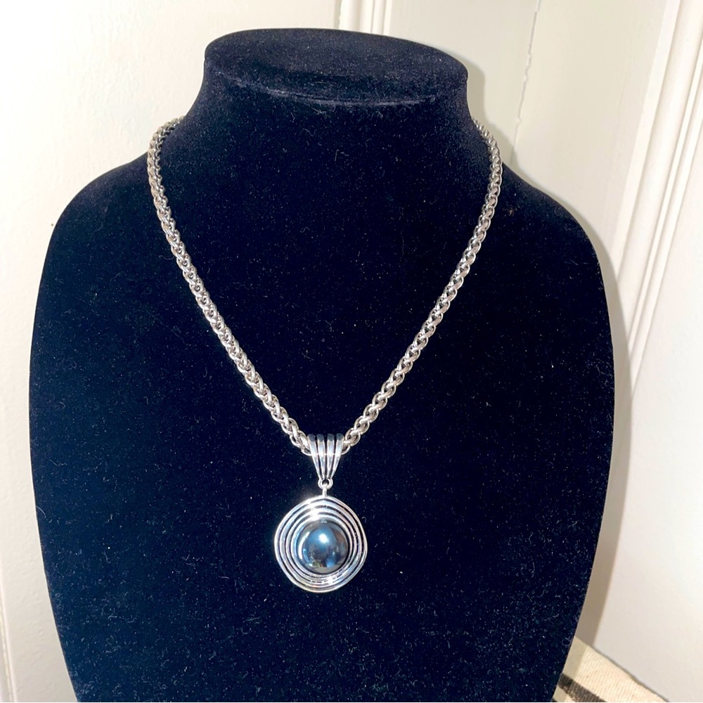 Large hematite pendant necklace on a thick silver chain.